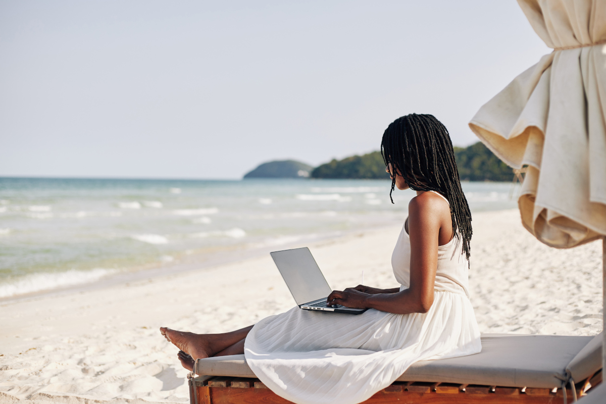 woman-resting-on-beach-with-laptop-2023-11-27-05-22-34-utc